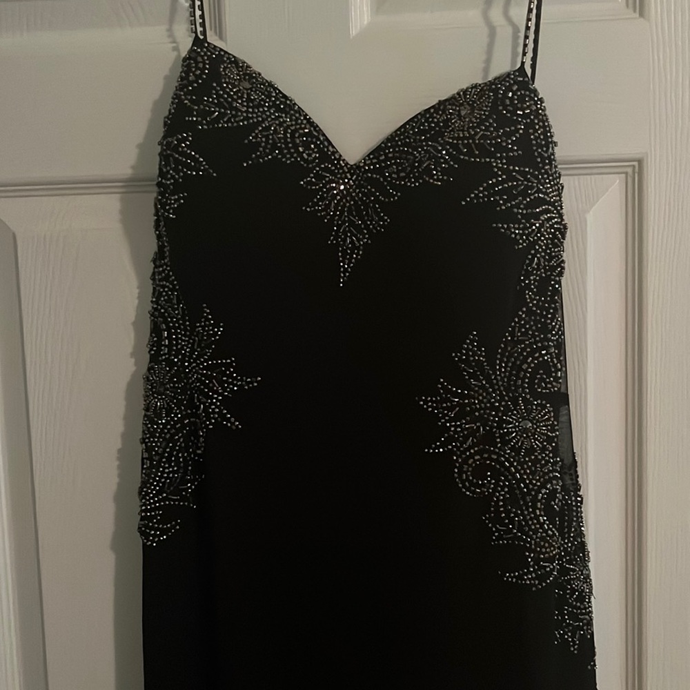Black fitted dress, silver beading around bust and waist. Madison James/ Size 16